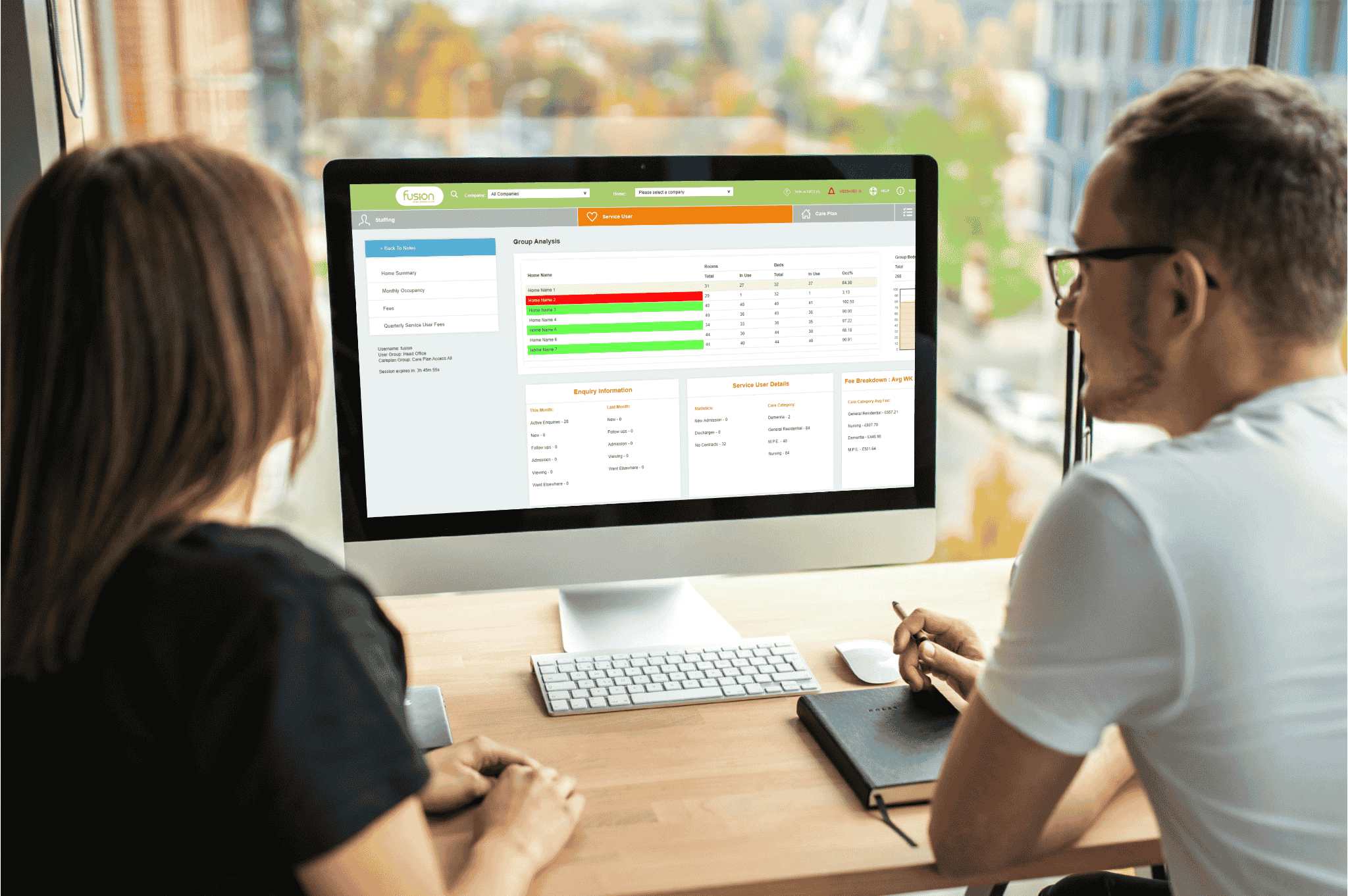 An image of 2 office admin staff working with Fusion's invoicing module on a computer